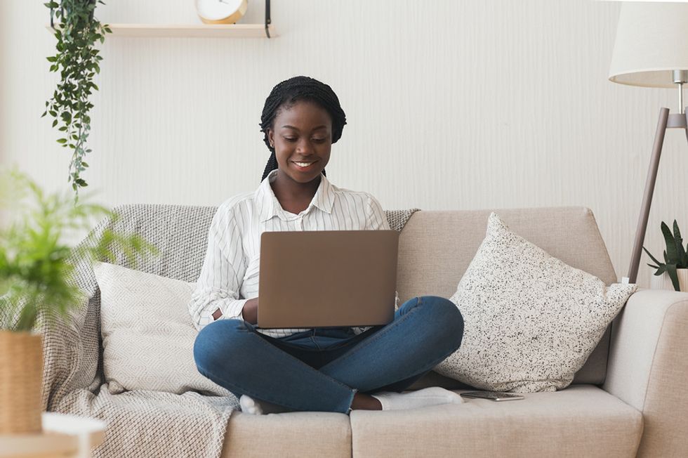 Woman on laptop is productive while working from home