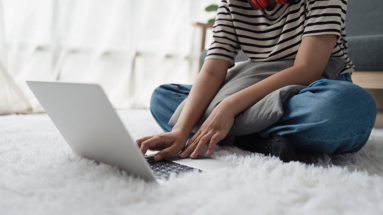Woman on laptop joins a LinkedIn Group