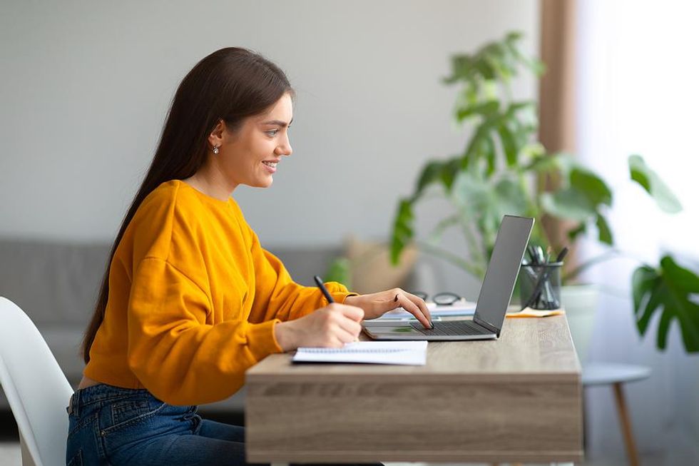 Woman on laptop looks for a new job