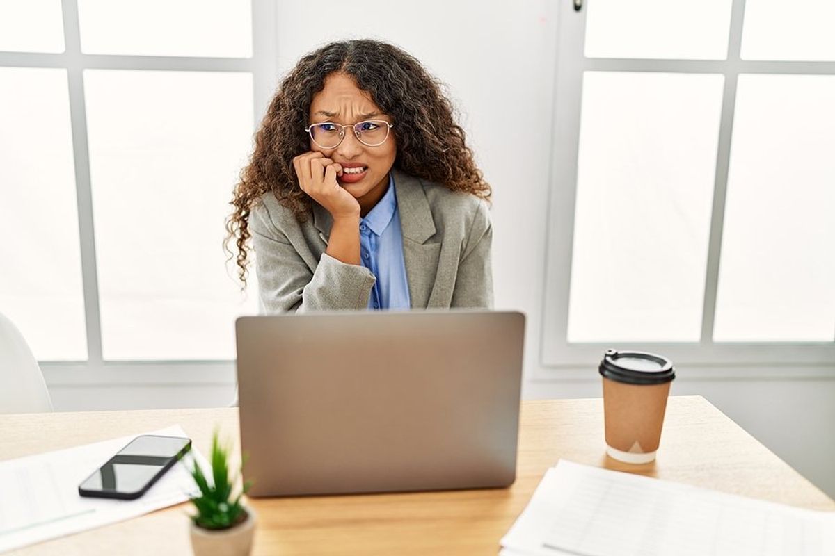 Woman on laptop nervous about online networking