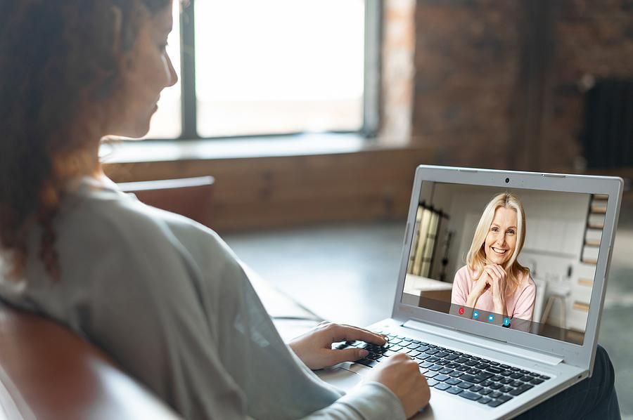 Woman on laptop offers value to someone in her professional network during a video call