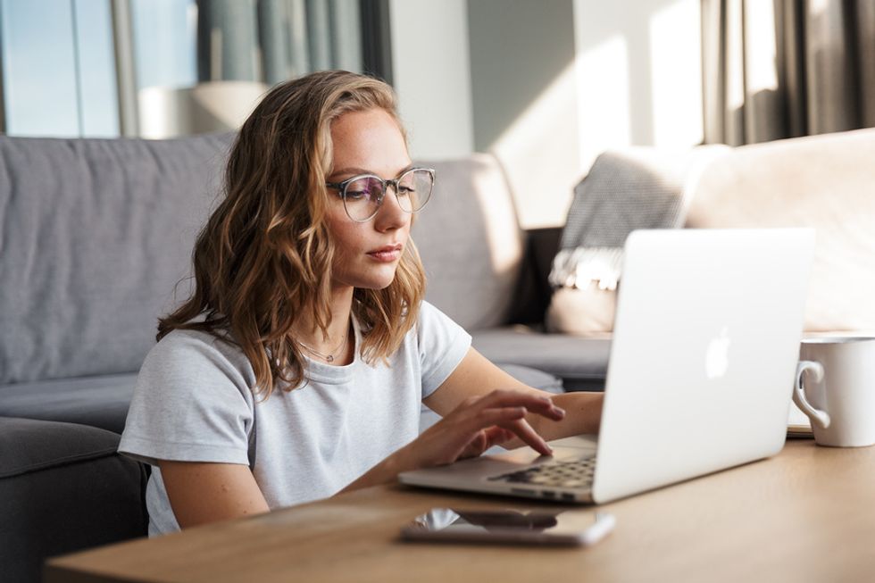 Woman on laptop pays back her unemployment insurance overpayment