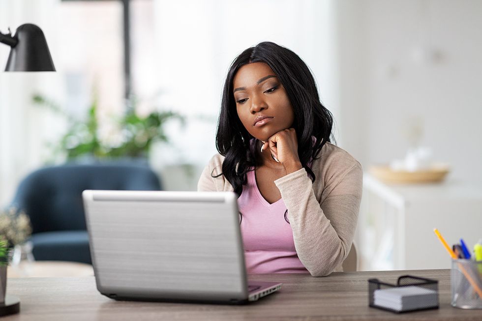 Woman on laptop proofreads her cover letter