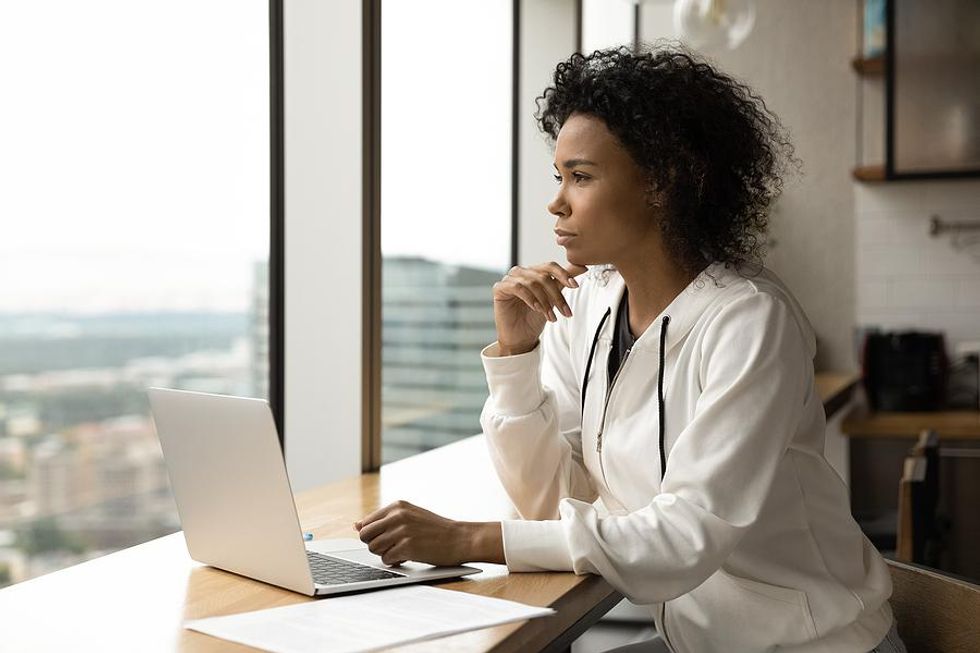 Woman on laptop realizes she got ghosted by a LinkedIn connection