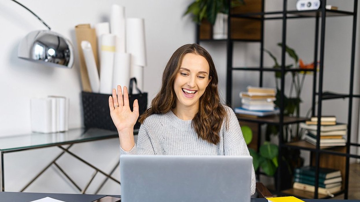 Woman on laptop records a video to stand out during an evidence-based hiring process