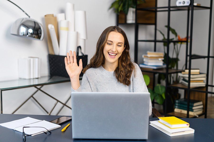 Woman on laptop records a video to stand out during an evidence-based hiring process