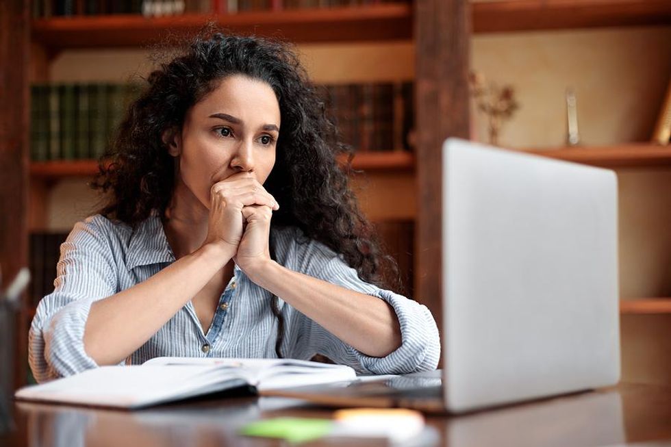 Woman on laptop regrets reaching out to a connection on LinkedIn