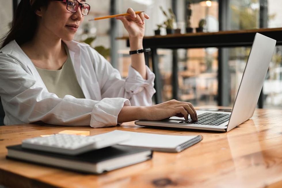 Woman on laptop researches a company before her job interview