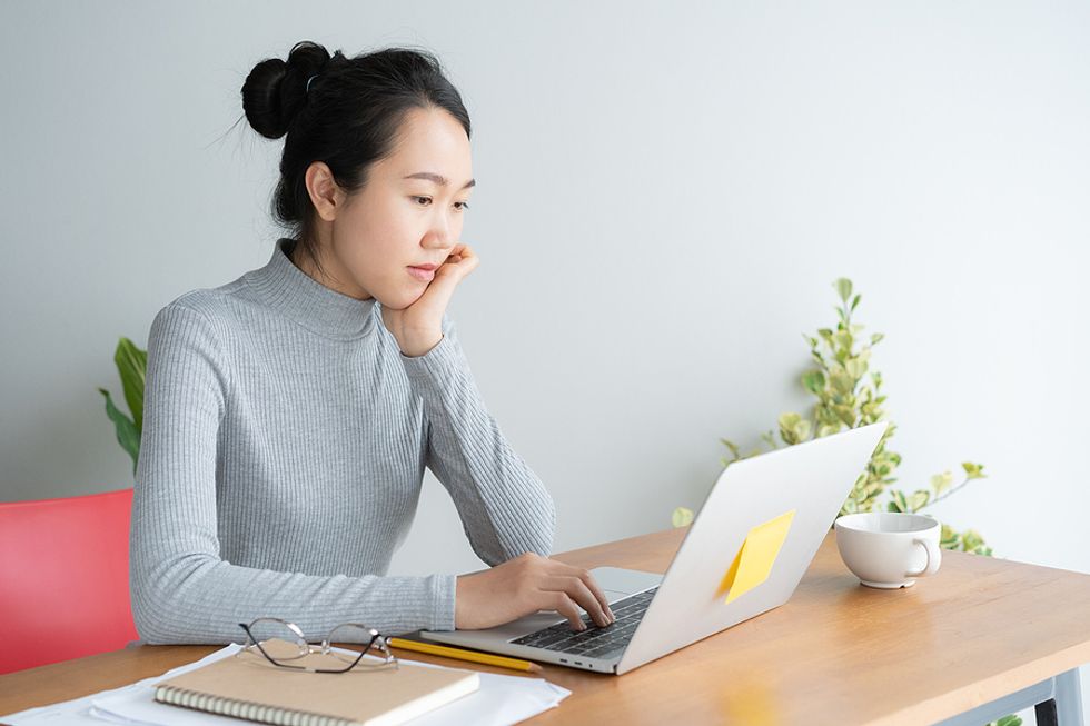 Woman on laptop researches effective job search tips