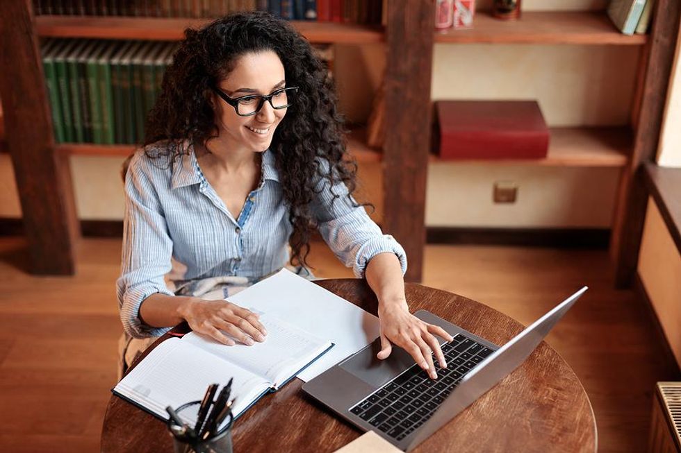 Woman on laptop sends a thank-you note to a hiring manager