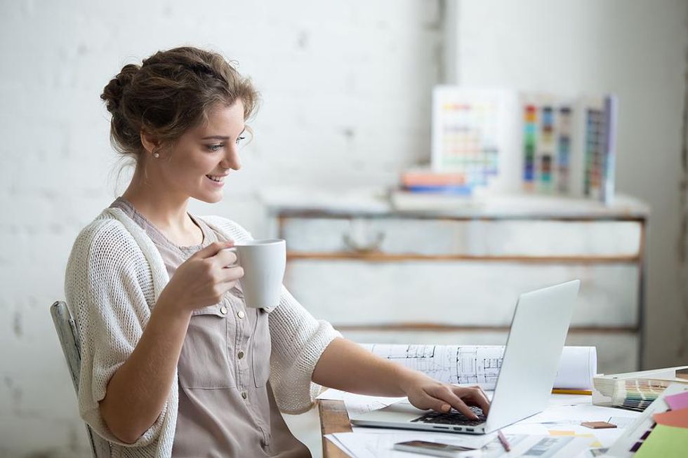 Woman on laptop shares an article with her network