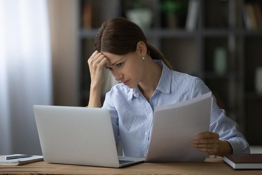 Woman on laptop stressed about work