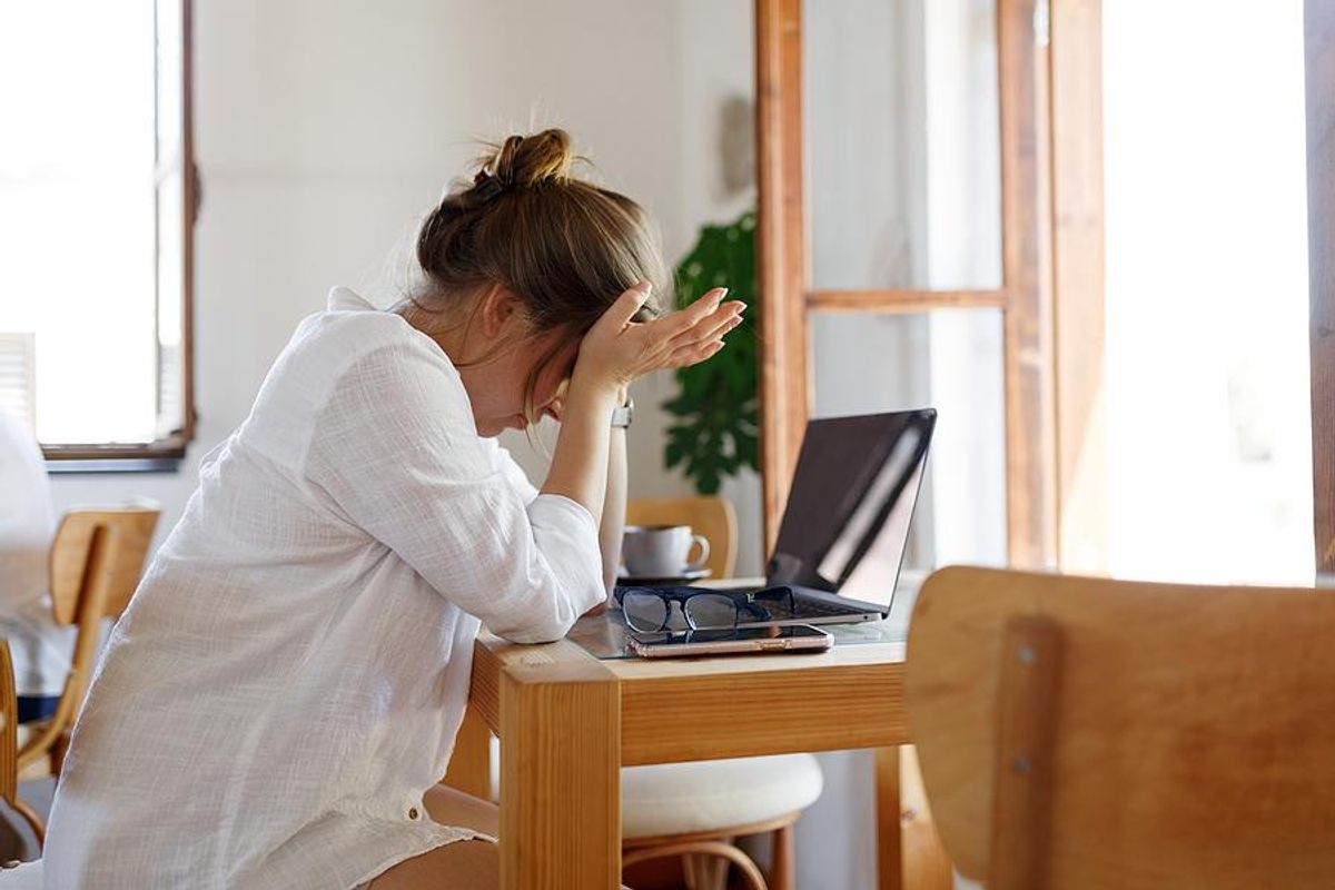 Woman on laptop stressed and frustrated about her job search