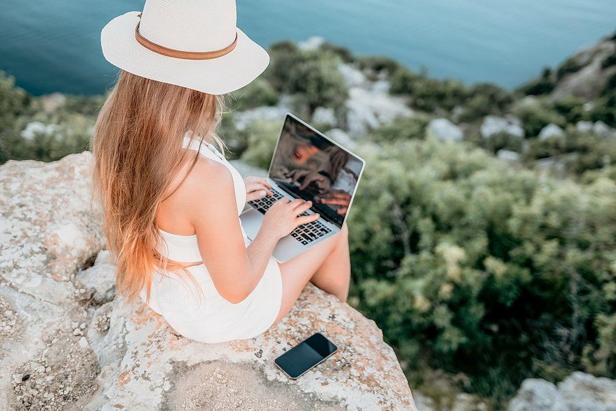 Woman on laptop takes a "working vacation"