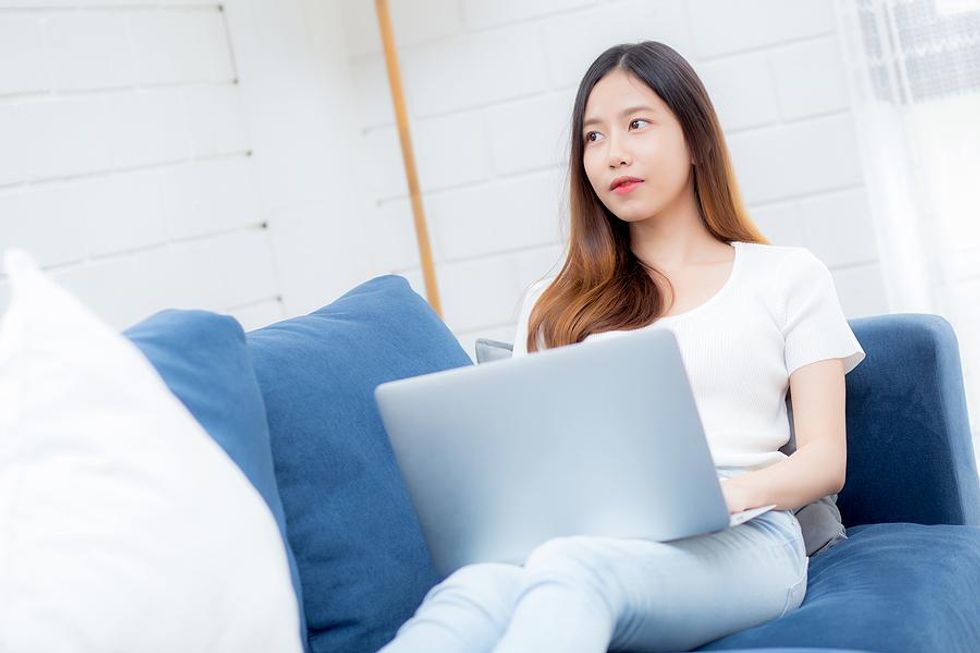 Woman on laptop thinks about accepting an invite on LinkedIn