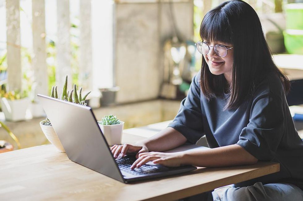 Woman on laptop tries to get her foot in the door at a company