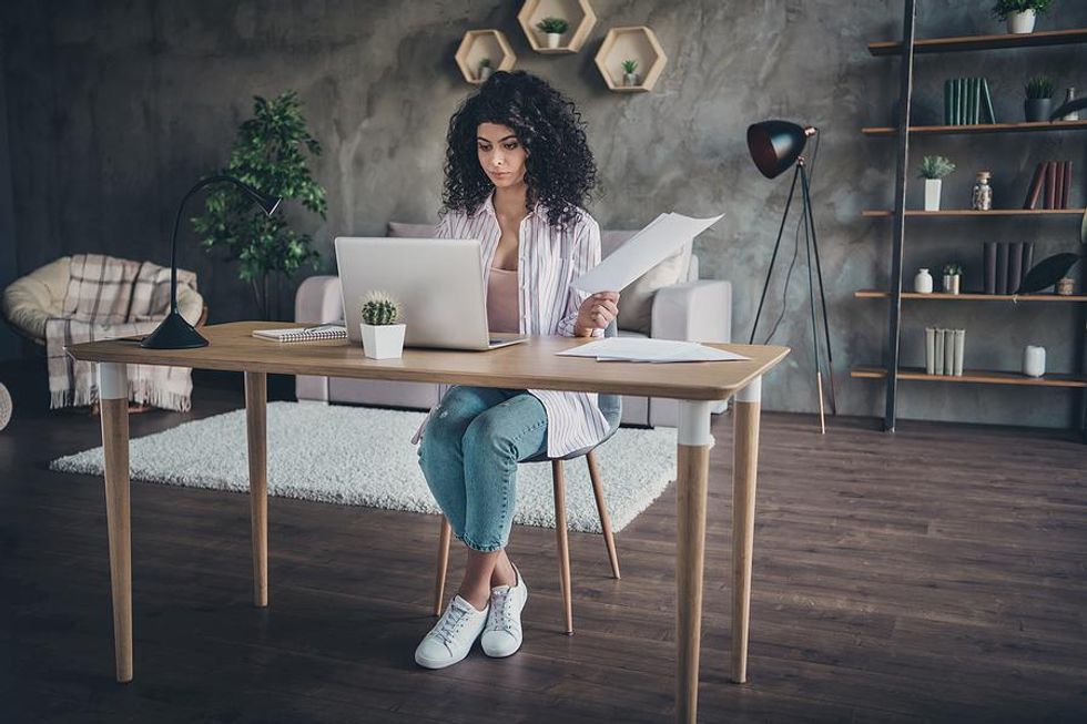 Woman on laptop updates her resume