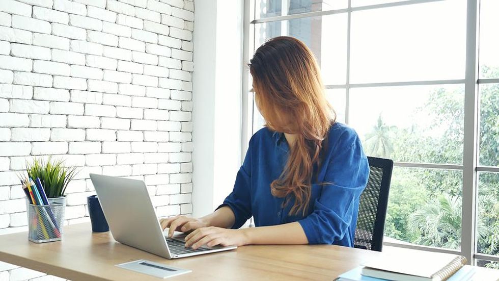 Woman on laptop updates her resume