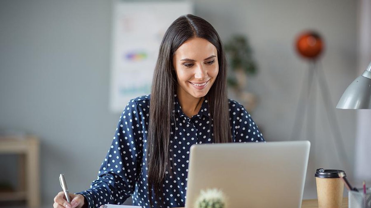 Woman on laptop works to customize her resume