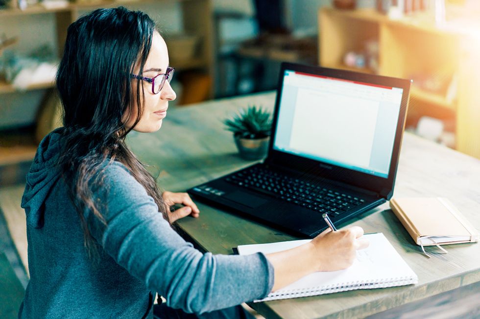 Woman on laptop writes a reference for a colleague