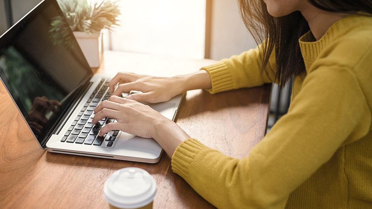 Woman on laptop writes a thank-you note after a job interview 