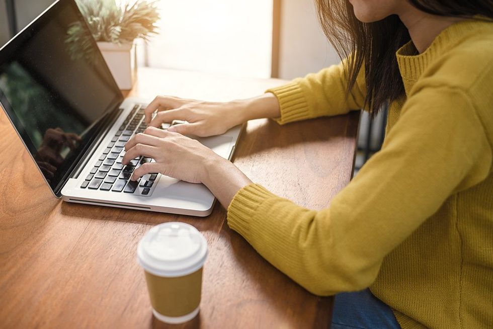 Woman on laptop writes a thank-you note after a job interview 