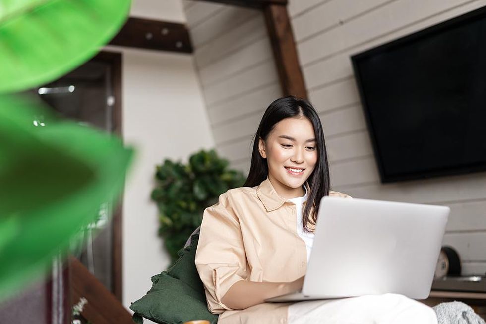 Woman on laptop writes her resume
