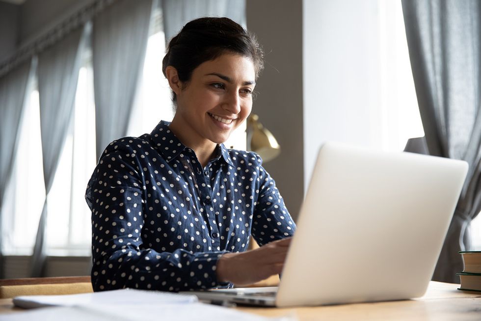 Woman on laptop writing her cover letter for a job posting