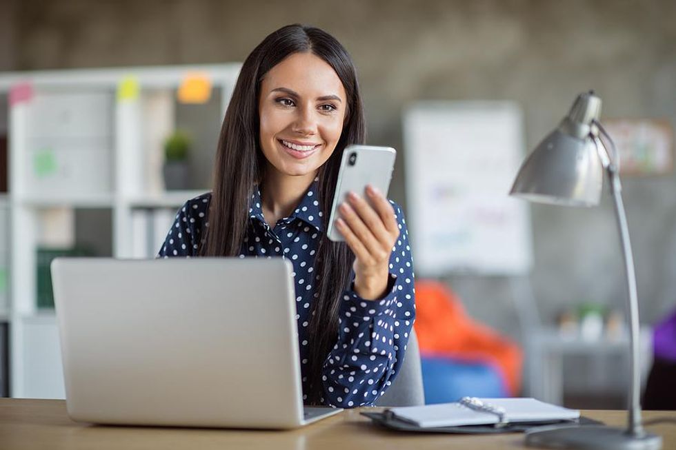 Woman on phone accepts a new connection request from someone on LinkedIn