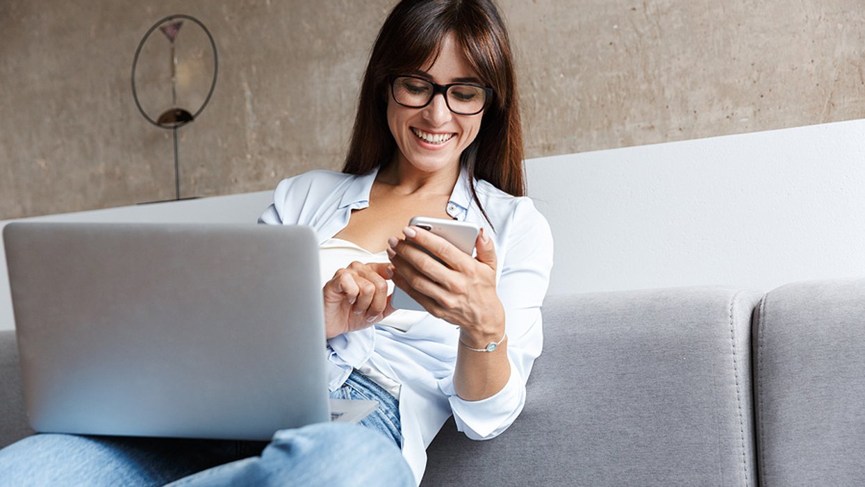Woman on phone and laptop takes advantage of being unemployed