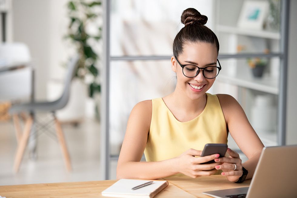 Woman on phone builds her personal brand on social media