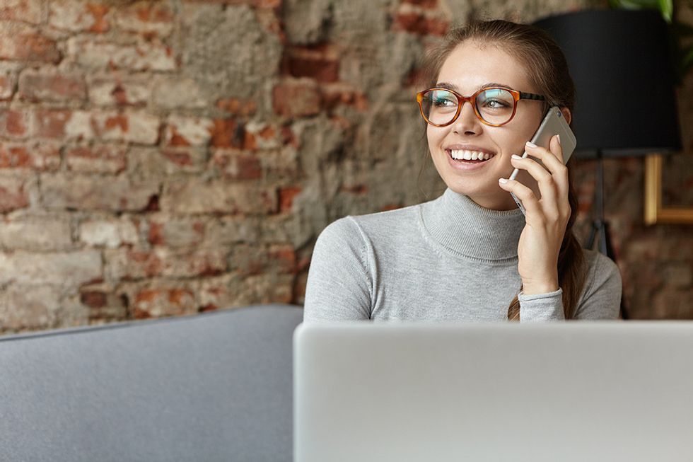 Woman on phone executes an effective job search strategy