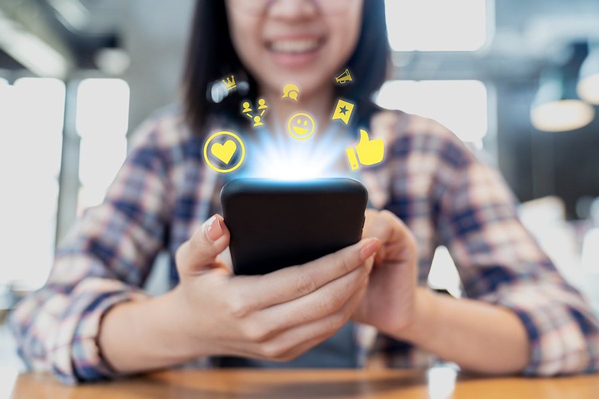 Woman on phone participates in and builds a community online