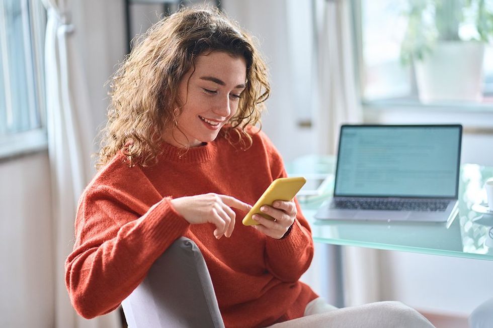 Woman on phone receives personalized content from brands