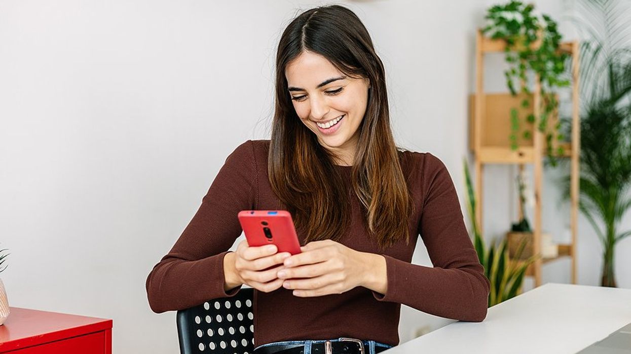 Woman on phone takes Work It Daily's free Career Decoder Quiz