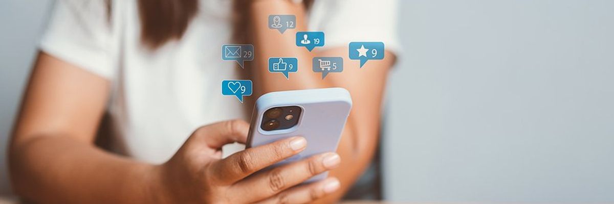 Woman on phone uses social media to post online content to generate sales