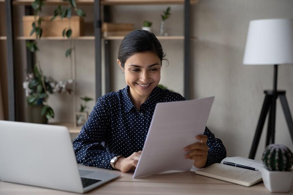 Woman reads her resume with quantifiable achievements