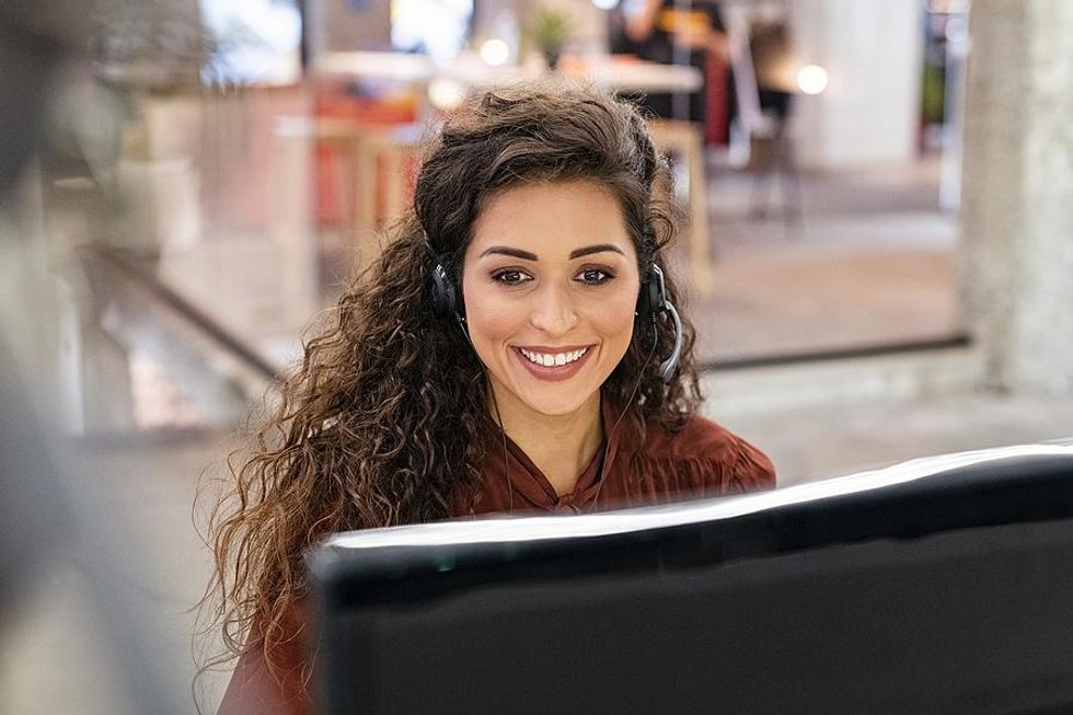 Woman salesperson talks to a customer on the phone