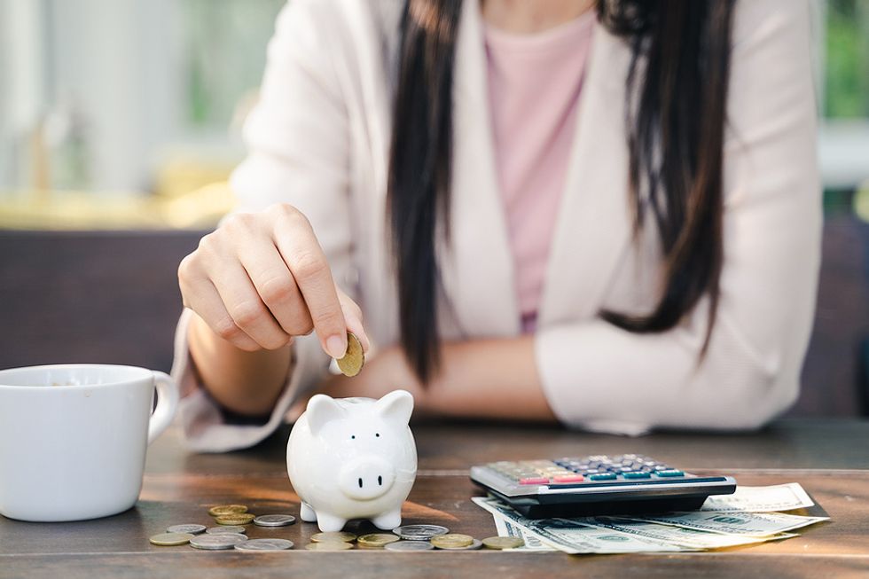 Woman saving money during the career change process