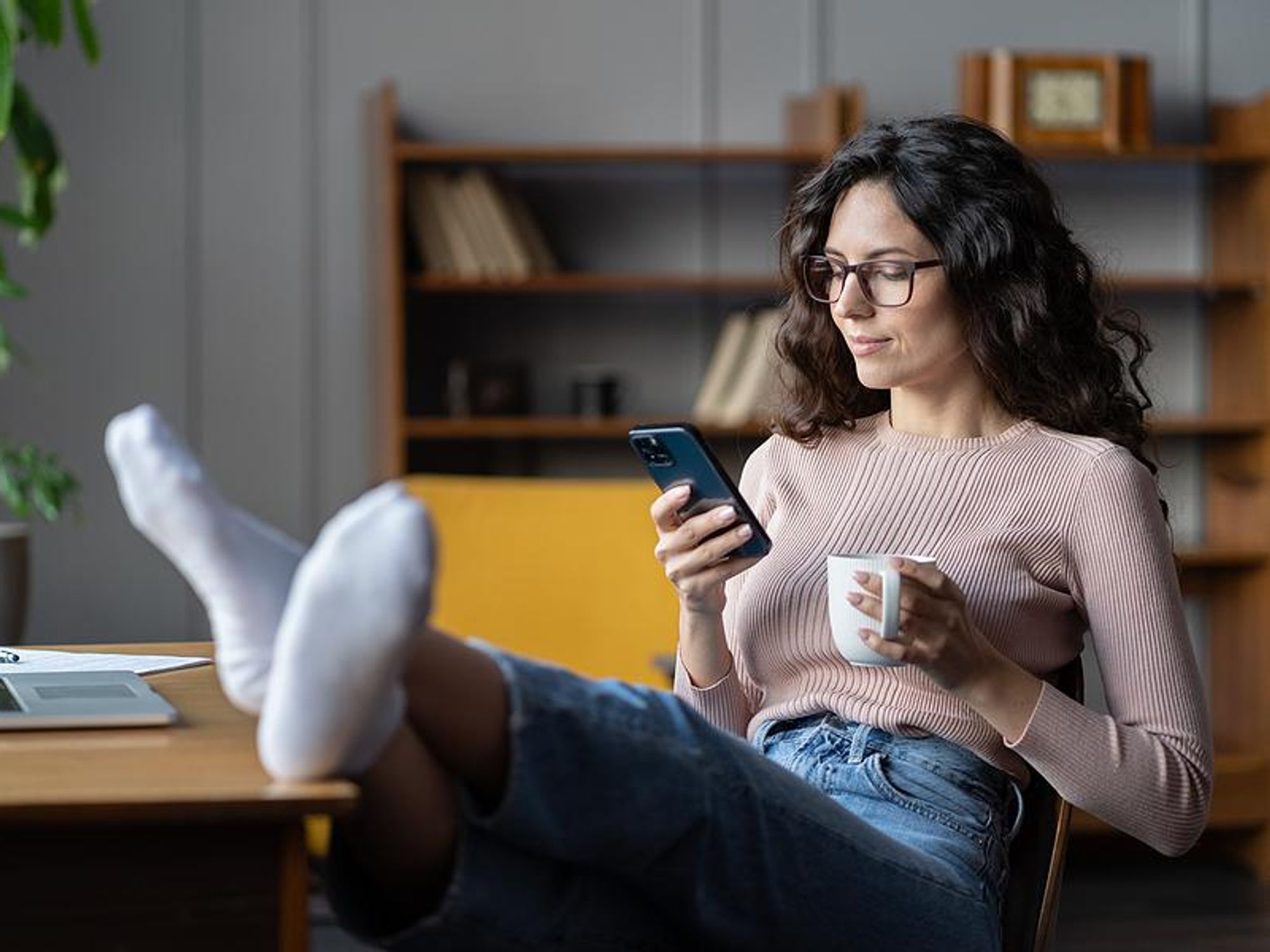 Woman scrolls through her phone
