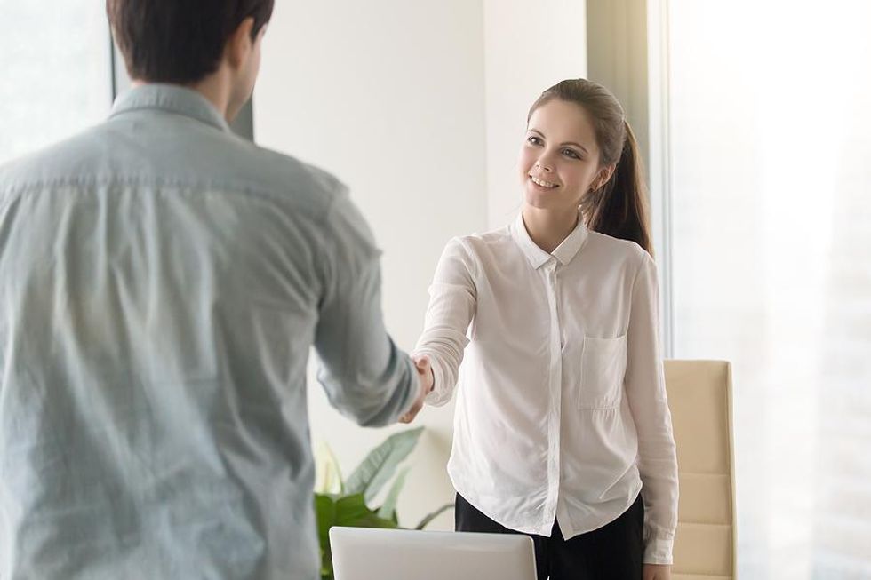 Woman shakes hands with a colleague after an informational interview