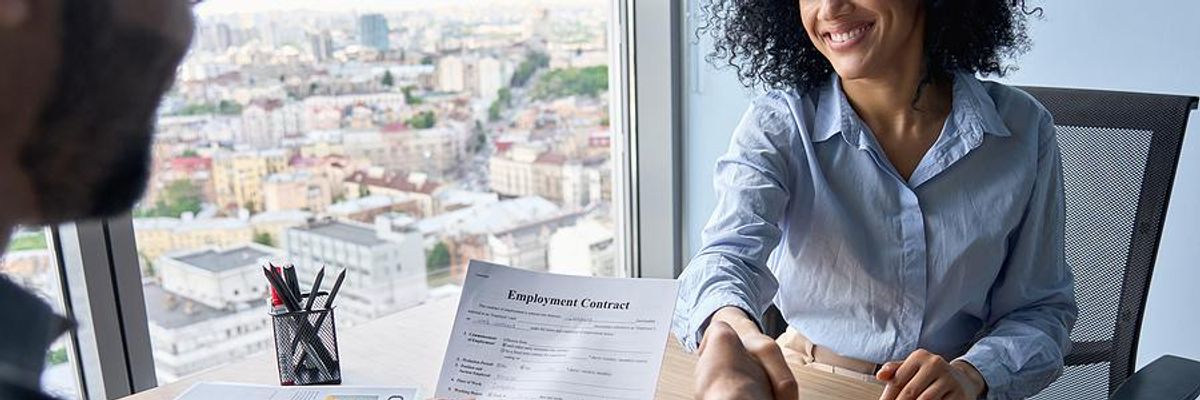 Woman shakes hands with the hiring manager after a job interview