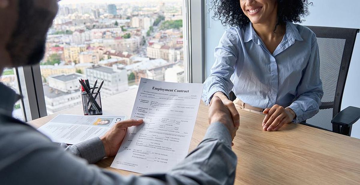 Woman shakes hands with the hiring manager after a job interview