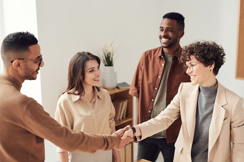 Woman shakes hands with the hiring manager
