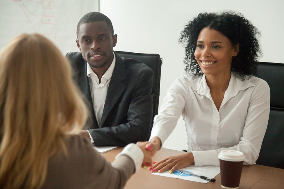 Woman shakes the hiring manager's hand before a job interview