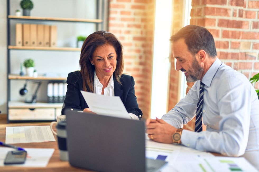 Woman shows a report to her new boss during a work meeting