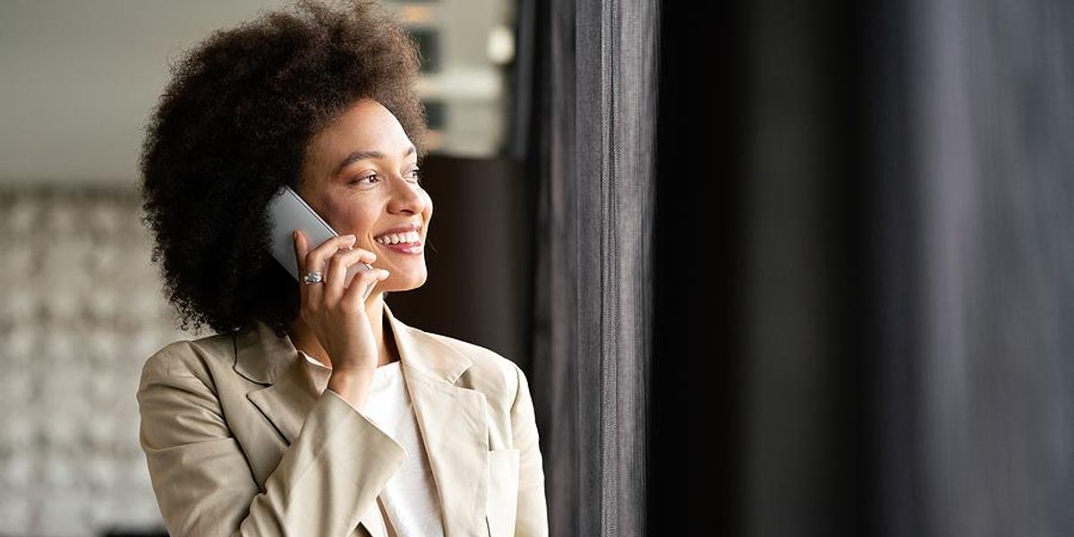 woman smiles during a phone interview
