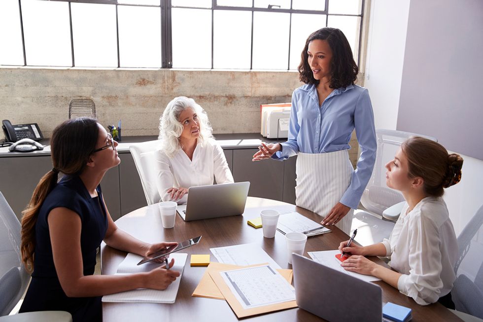 Woman stands out as a leader during a work meeting