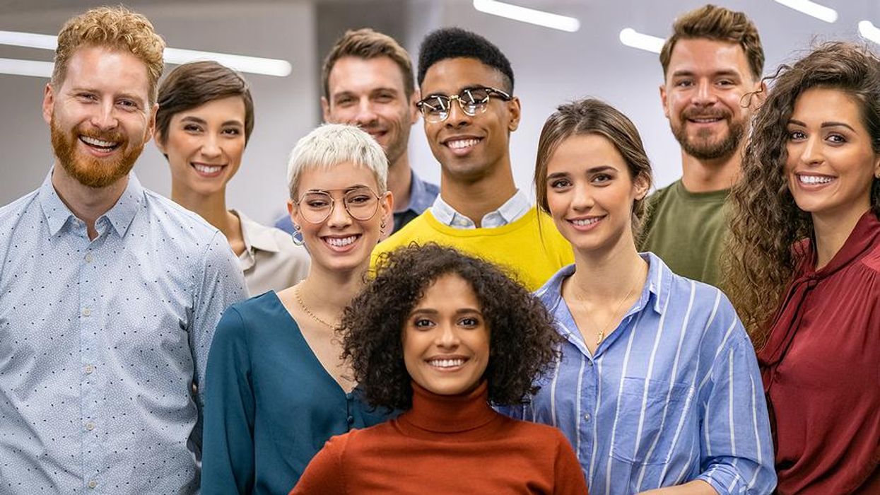 Woman stands with her coworkers/professional network