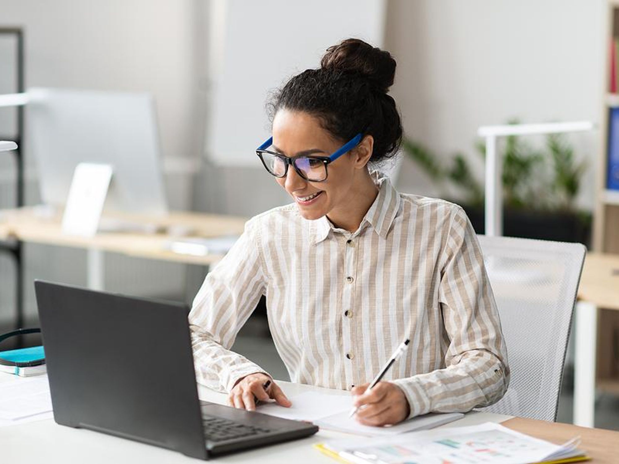 Woman takes notes at work